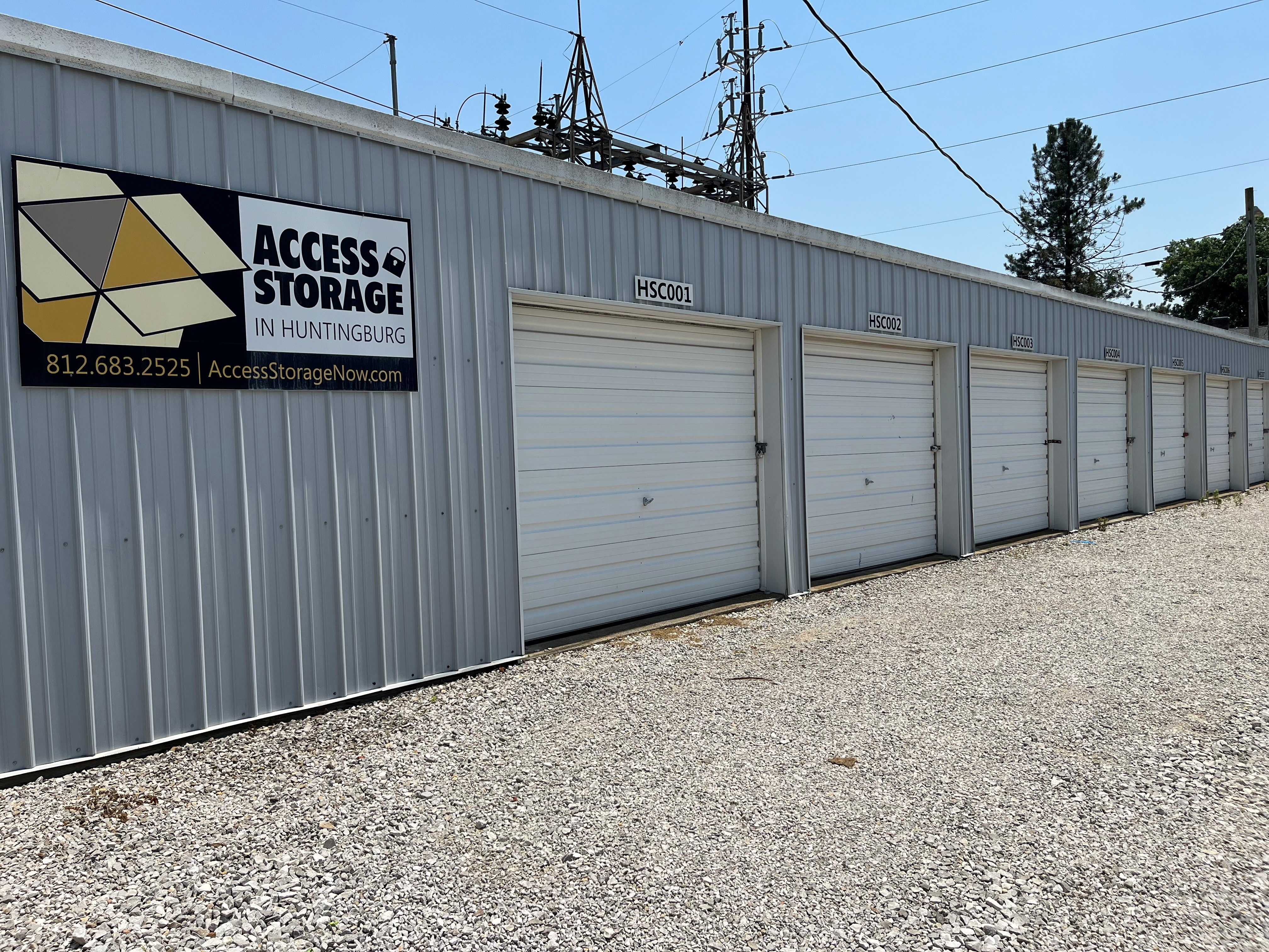 Secure, white-door storage units in Huntingburg with smooth paved driveways for easy drive-up access.